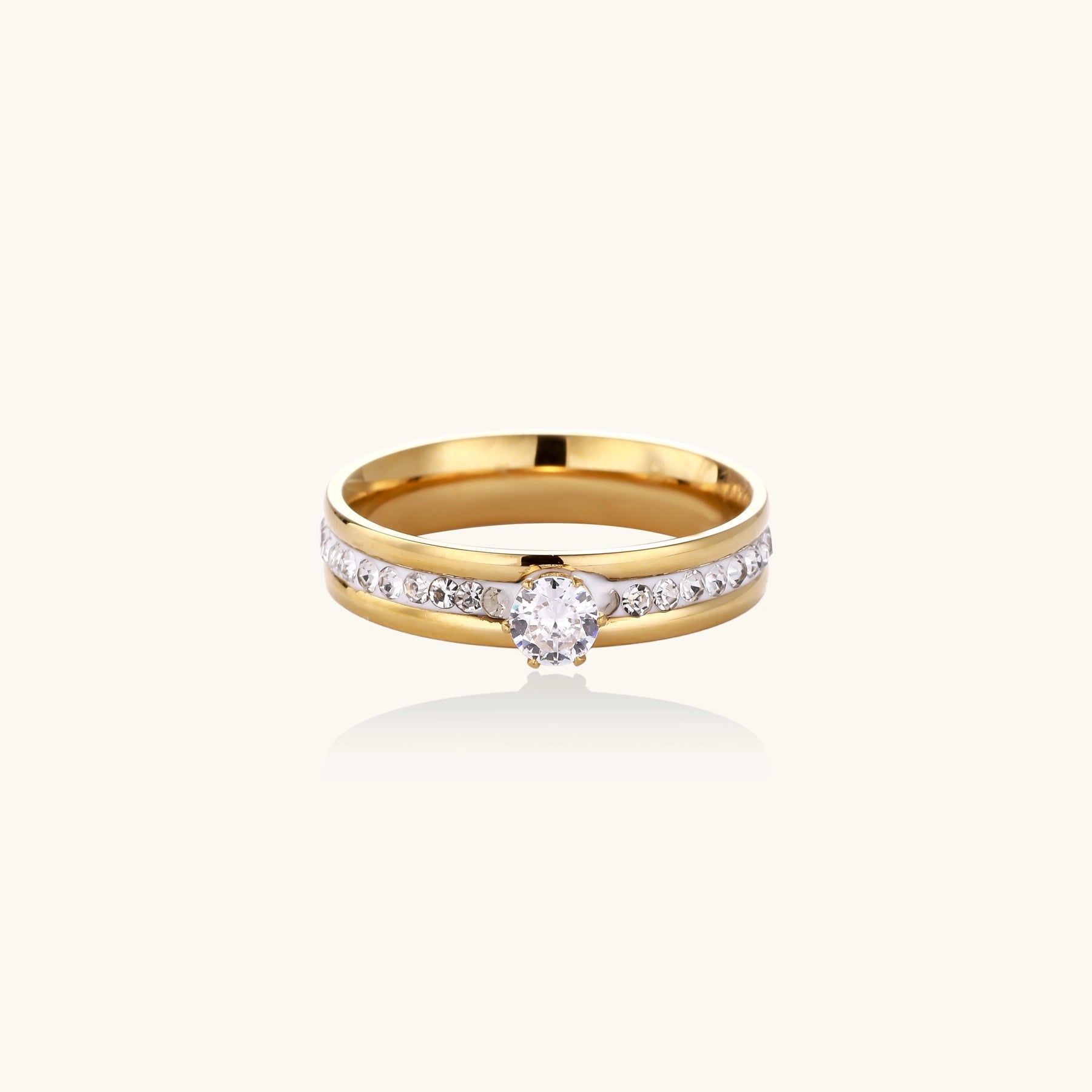 14K gold plated ring with center rhinestone and accent stones along the band on white background.